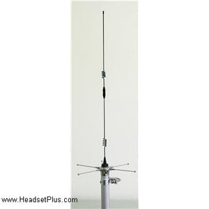 Tall outdoor whip antenna mounted on a mast with ground-plane radials at its base